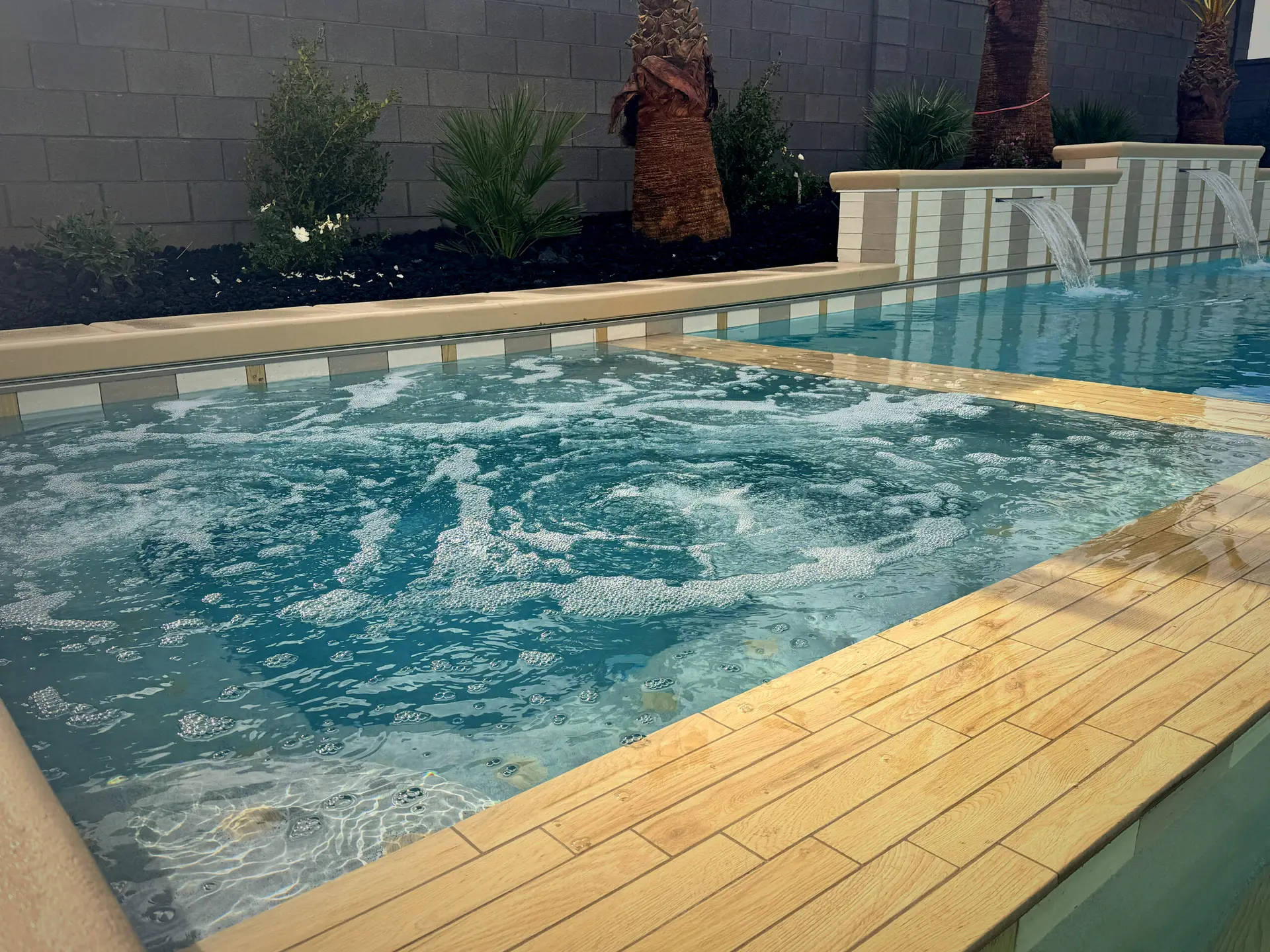 Luxury pool with integrated spa and spillover edge in a Southern Utah backyard
